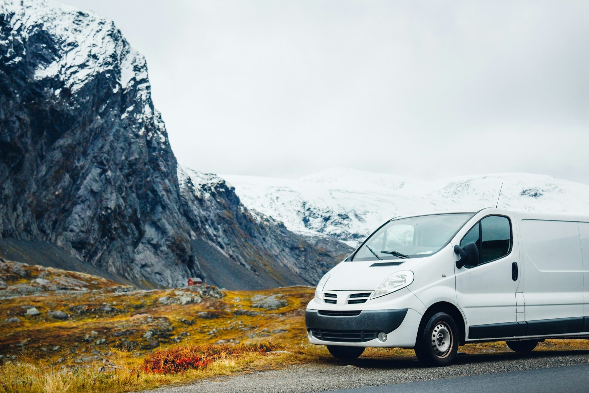 White van parked near mountains on a road trip